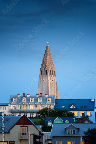 Steeple Hallgrimskirkja Lutheran parish church among the urban village in the dawn at Reykjavik, Iceland photo