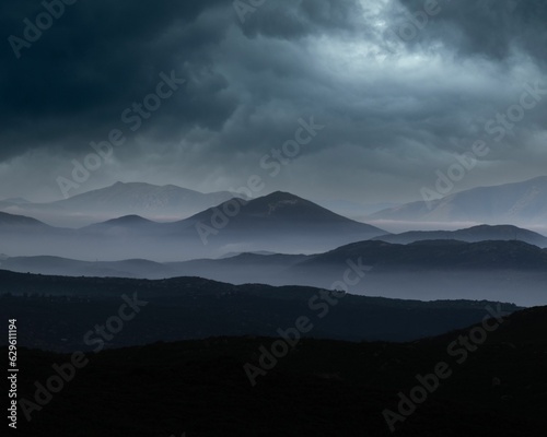 Картината върху платно Landscape of rocky mountains on a dark cloudy day with overcast