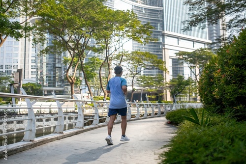 An unidentified man jogging in a urban scenery.