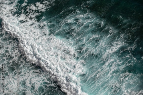 The ocean waves crashing on the shore