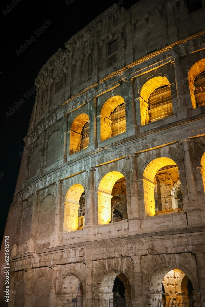 Iconic Coliseum of Rome, Italy illuminated by the lights at night