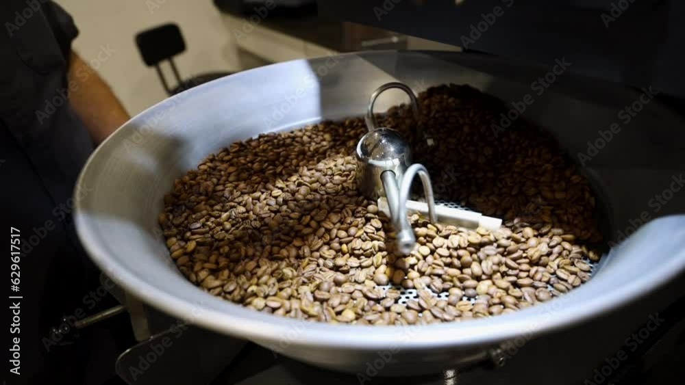 Closeup video of the process of roasting bright brown coffee beans