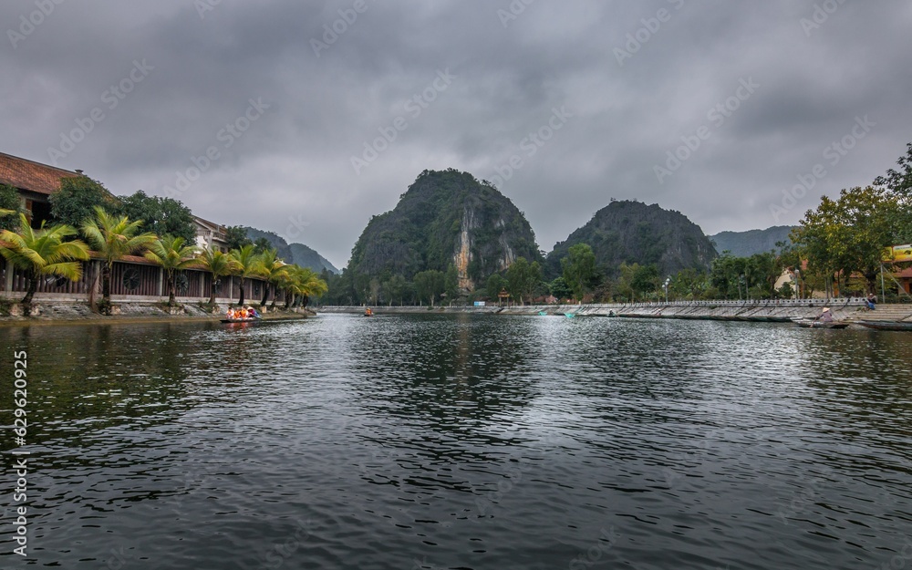 Tranquil lake in Vietnam surrounded by lush green mountains