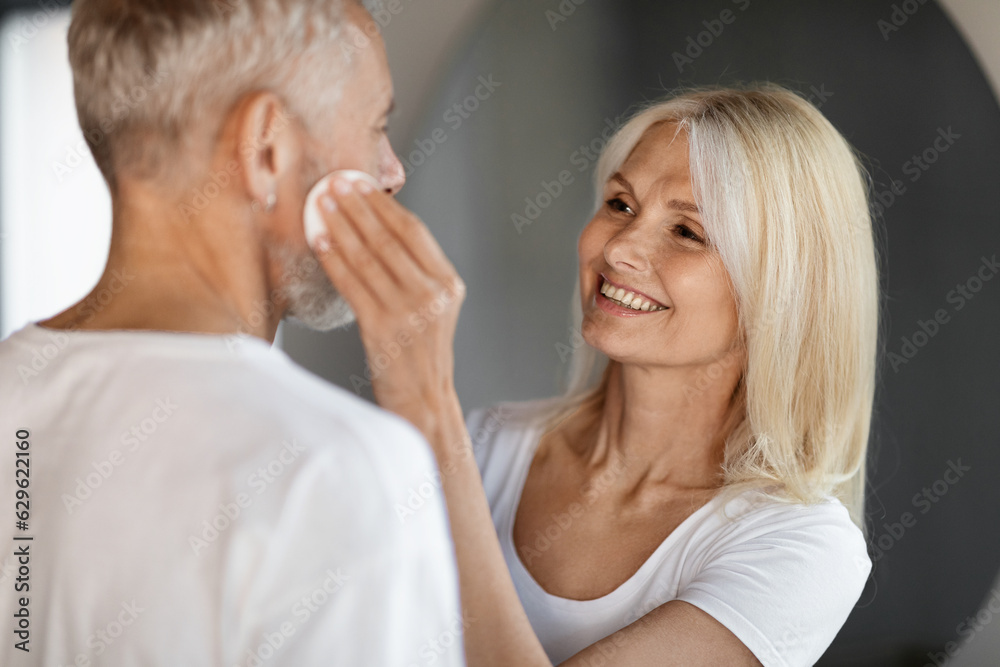 Home Skin Care. Mature Couple Making Anti-Aging Beauty Routine In Bathroom Together Home Skin Care. Mature Couple Making Anti-Aging Beauty Routine In Bathroom Together