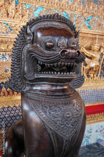 closeup of a bronze statue of a mythical creature in The Temple of the Emerald Buddha in Bangkok