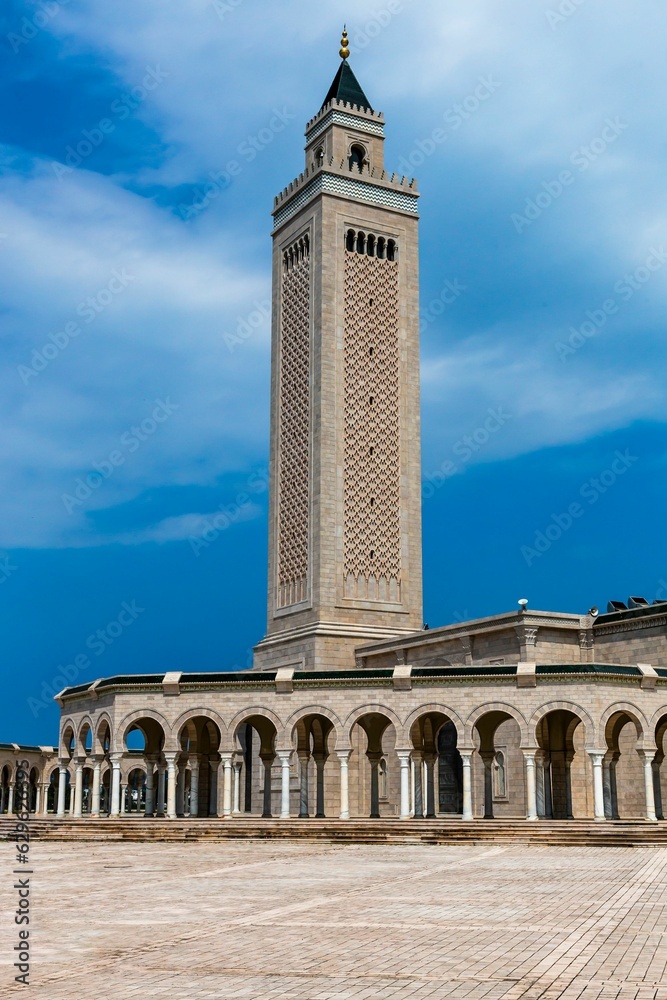 Fototapeta premium Stunning shot of a mosque in Tunisia, surrounded by an azure blue sky