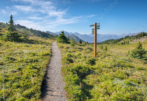 Hiking trail with directional sign post at Sunshine Meadows on the Continental Divide between Alberta and British Columbia