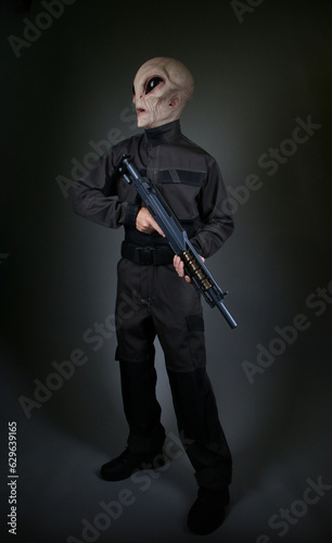 Male Alien Soldier Standing with Gun 
