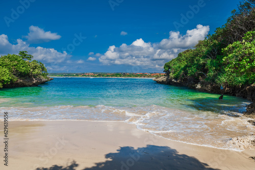Holiday beach with tropical trees  sand and blue ocean.