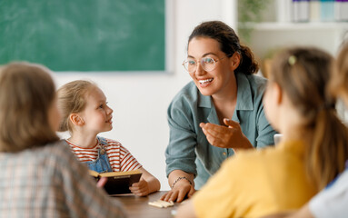 Happy kids and teacher at school