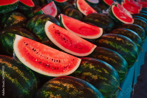 Fresh watermelons sale in the traditional farm Turkish market, a counter filled with fresh fruits
