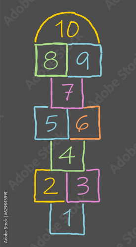 Hand drawn hopscotch game with different colors on a dark background. Irregular squares drawn by a child. photo