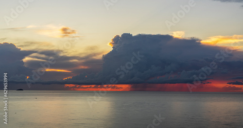 Cumulonimbus at dawn with reddish sky.