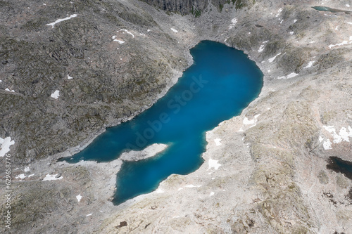 aerial close-up view of the dark lake below the crest presena in trentino photo