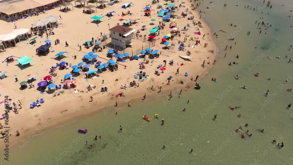 Locals and tourists enjoying a summer weekend day at the beach Locals and tourists enjoying a summer weekend day at the beach