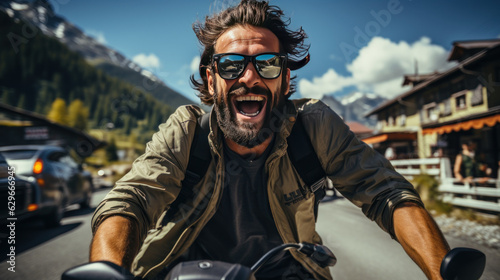 Happy man riding a scooter in a mountain village.