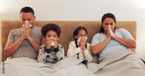 Sick, bed and family blowing their nose while relaxing together with a cold, flu or allergies. Illness, rest and parents in hayfever recovery with their children in the bedroom of their modern house. photo