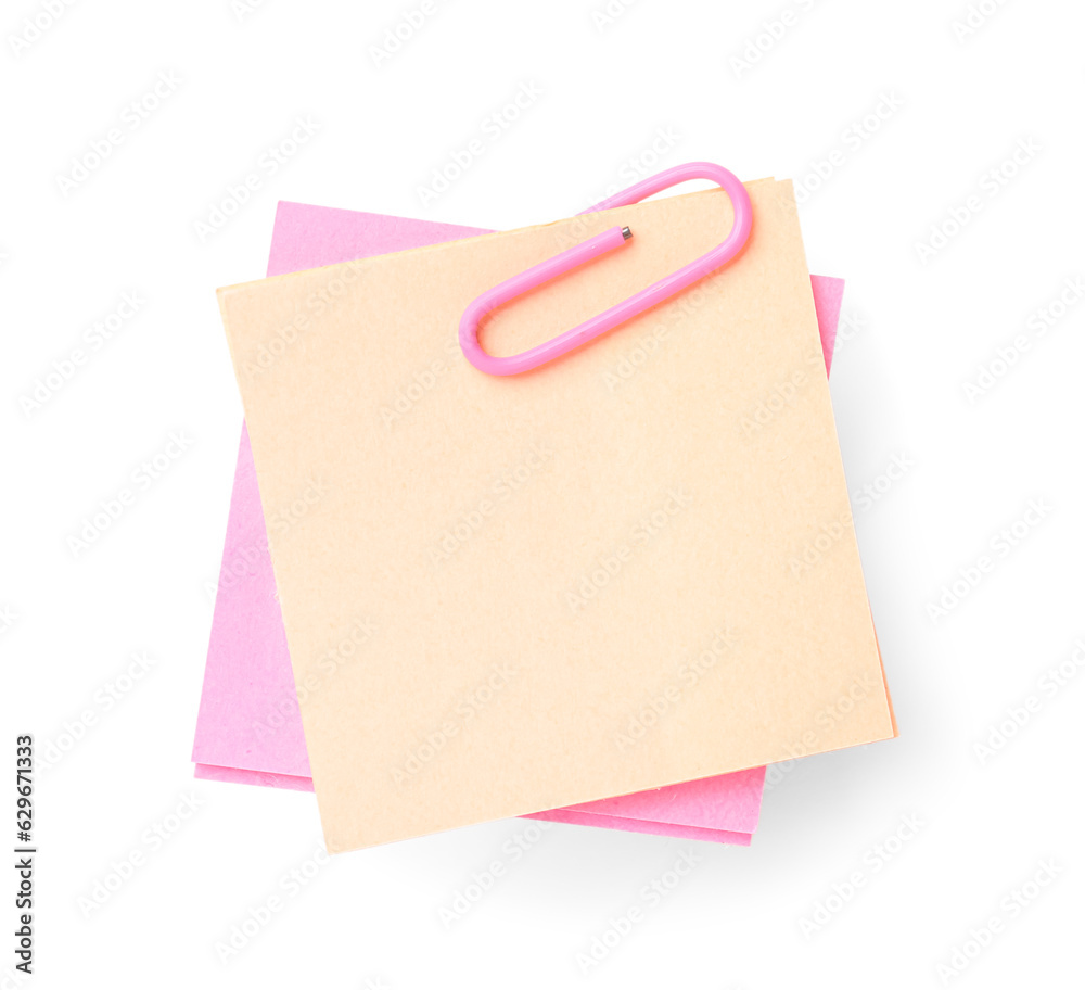 Pink and beige sticky notes with paper clip on white background Pink and beige sticky notes with paper clip on white background