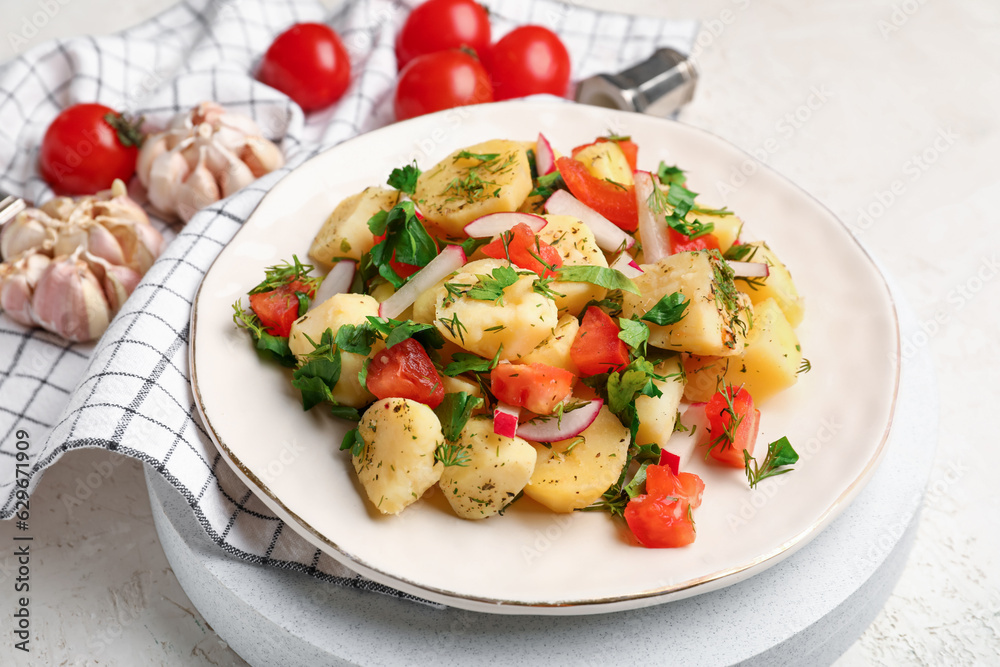 Plate of tasty Potato Salad with vegetables on light background Plate of tasty Potato Salad with vegetables on light background