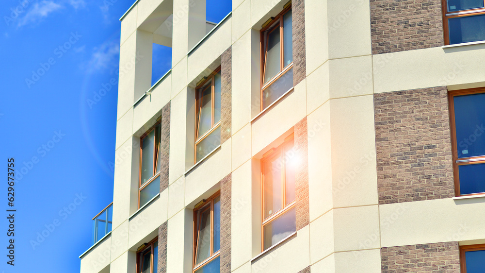 Modern apartment buildings on a sunny day with a blue sky. Facade of a modern apartment building Modern apartment buildings on a sunny day with a blue sky. Facade of a modern apartment building