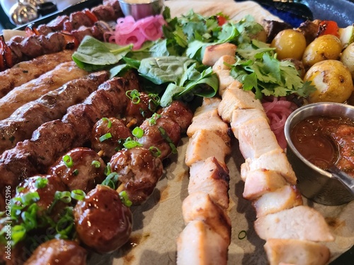 Assorted: shish kebab from poultry, pork, shrimps, vegetables, potatoes photo