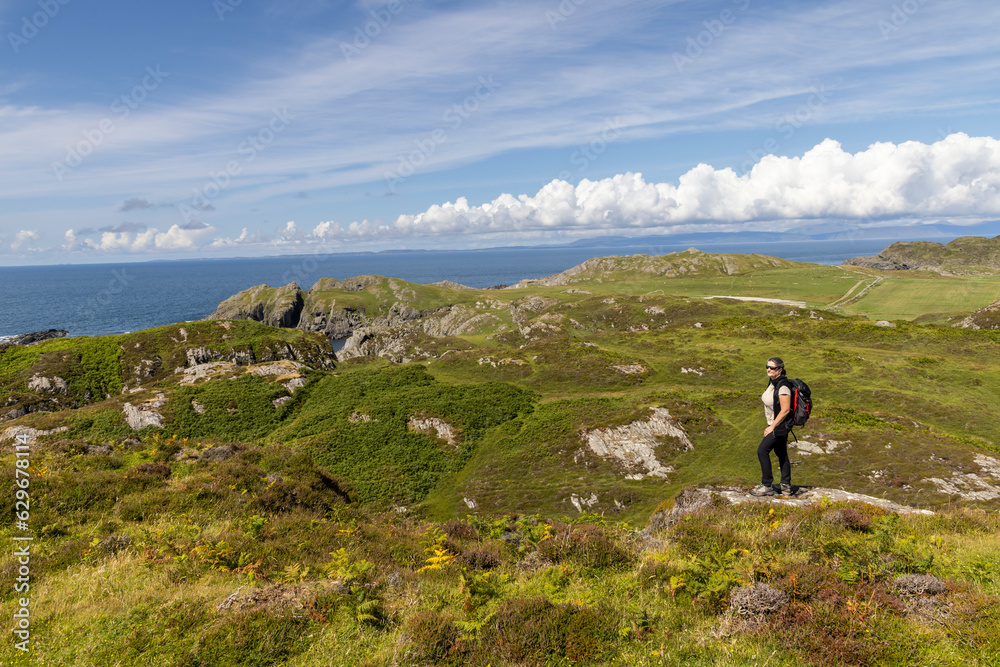woman hiking on the cliffs of Balnahard on the isle of Colonsay, Scotland