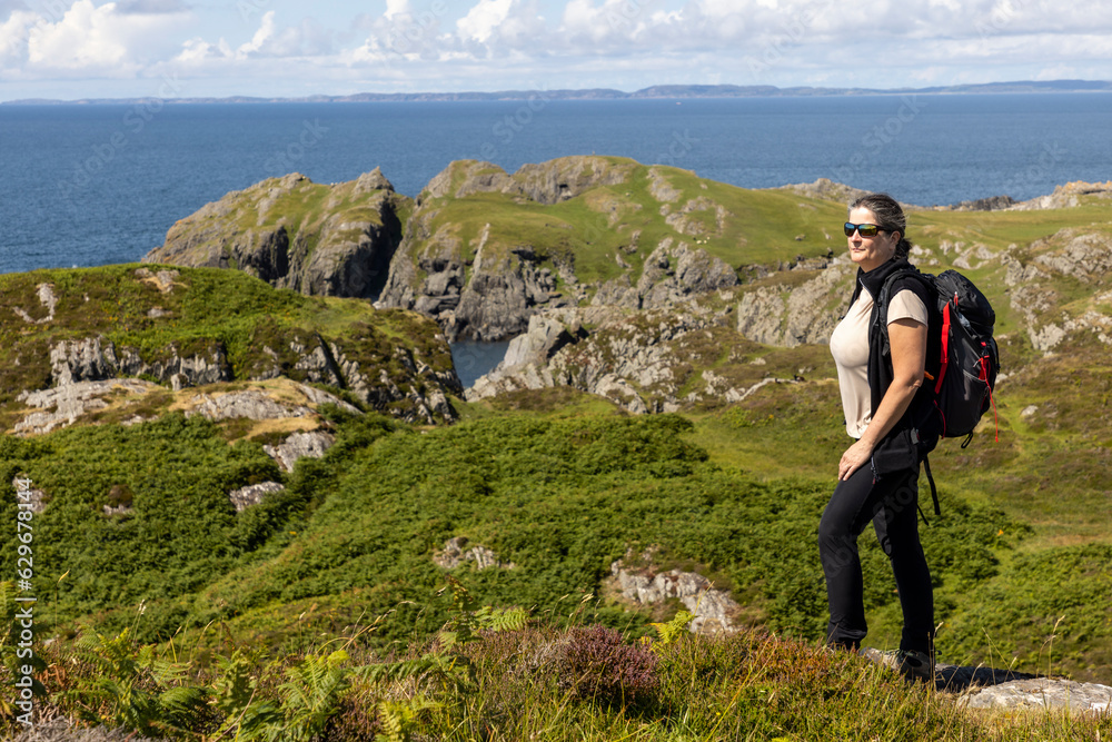 woman hiking on the cliffs of Balnahard on the isle of Colonsay, Scotland
