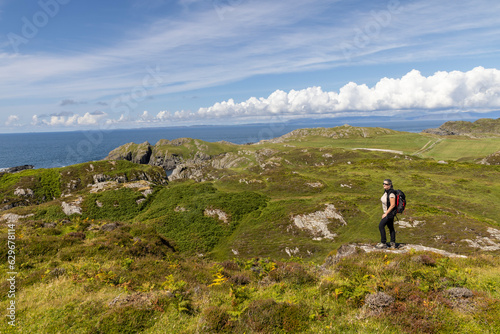 Obraz na płótnie woman hiking on the cliffs of Balnahard on the isle of Colonsay, Scotland w salonie
