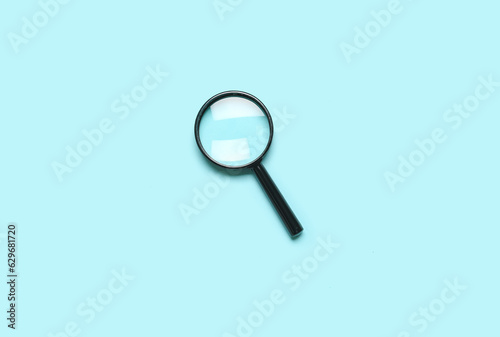 Black mini magnifier on blue background