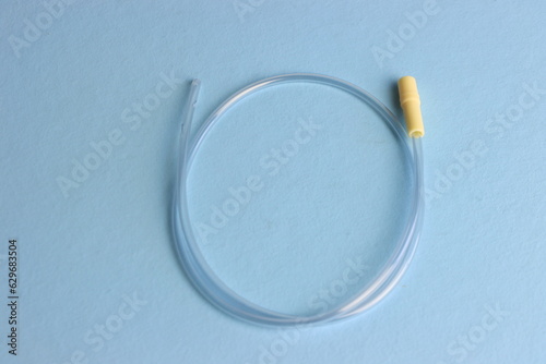 Tracheal suction cannula 10frin a light blue background. Top view