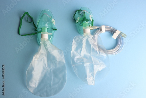 Top view of an Adult and pediatric oxygen mask in a light blue background. photo