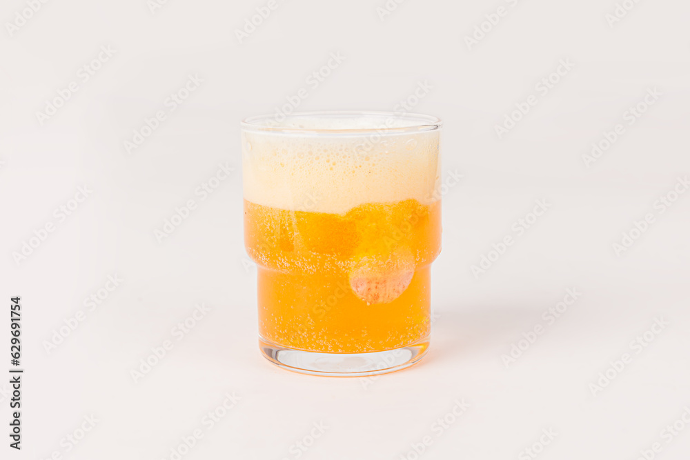 Orange vitamin C effervescent tablet dropped and dissolve in glass of water with bubbles isolated on white background Orange vitamin C effervescent tablet dropped and dissolve in glass of water with bubbles isolated on white background