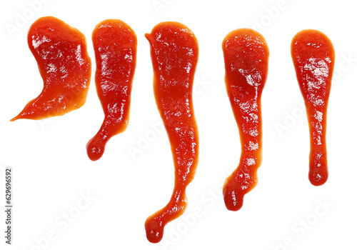 Red ketchup splashes isolated on white background, tomato puree texture photo