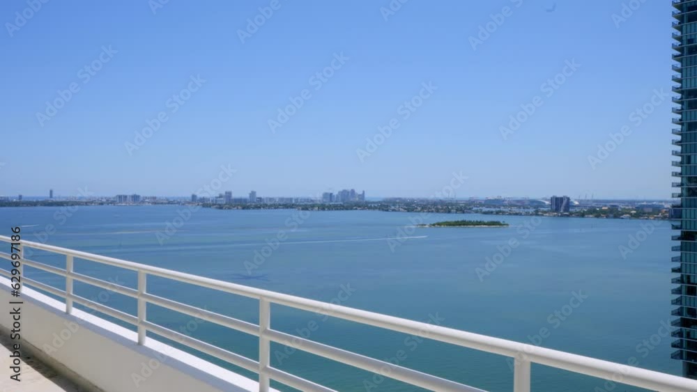 White penthouse balcony with amazing scenery on Venetian Islands in Miami Beach. Luxury modern estate property with stunning ocean view. Concept of tourism and summer vacation White penthouse balcony with amazing scenery on Venetian Islands in Miami Beach. Luxury modern estate property with stunning ocean view. Concept of tourism and summer vacation