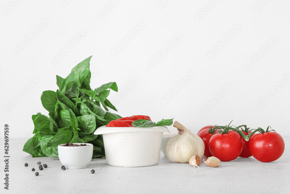 Bowl of canned tomatoes and spices on light background Bowl of canned tomatoes and spices on light background