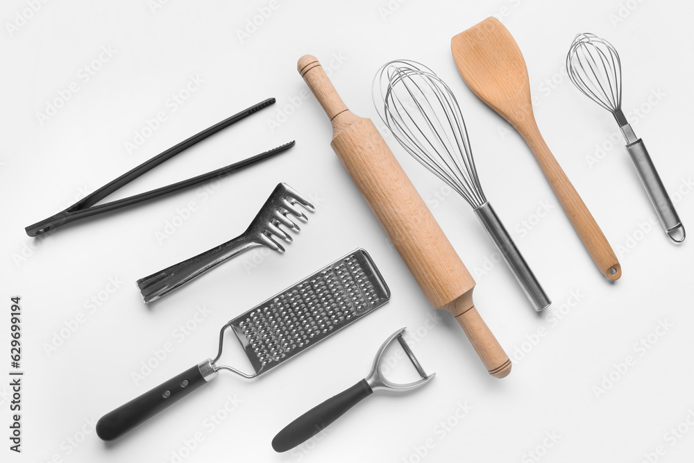 Composition with different kitchen utensils on light background Composition with different kitchen utensils on light background