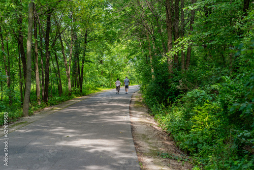 People Walking On The Fox River Trail Near De Pere, Wisconsin, In Summer