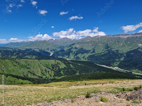 Amazing mountains in summer. Green forest against a cloudy sky. Arkhyz, Karachay-Cherkessia, Russia