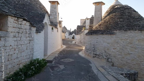 Alberobello Italy - traditional trulli houses with conical stone roofs. Famous landmark, travel destination and tourist attraction near Bari in Puglia, Europe. Street with ancient architecture.