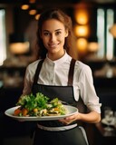 Young waitress presents a dish with Caesar Salad - food photography