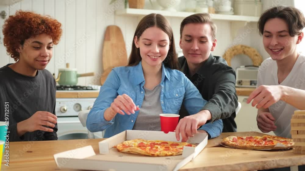 Home party. Overjoyed diverse friends eating ordered pizza for home party. Happy group mixed race young buddies enjoying spending free weekend time together having fun laughing joking communicating