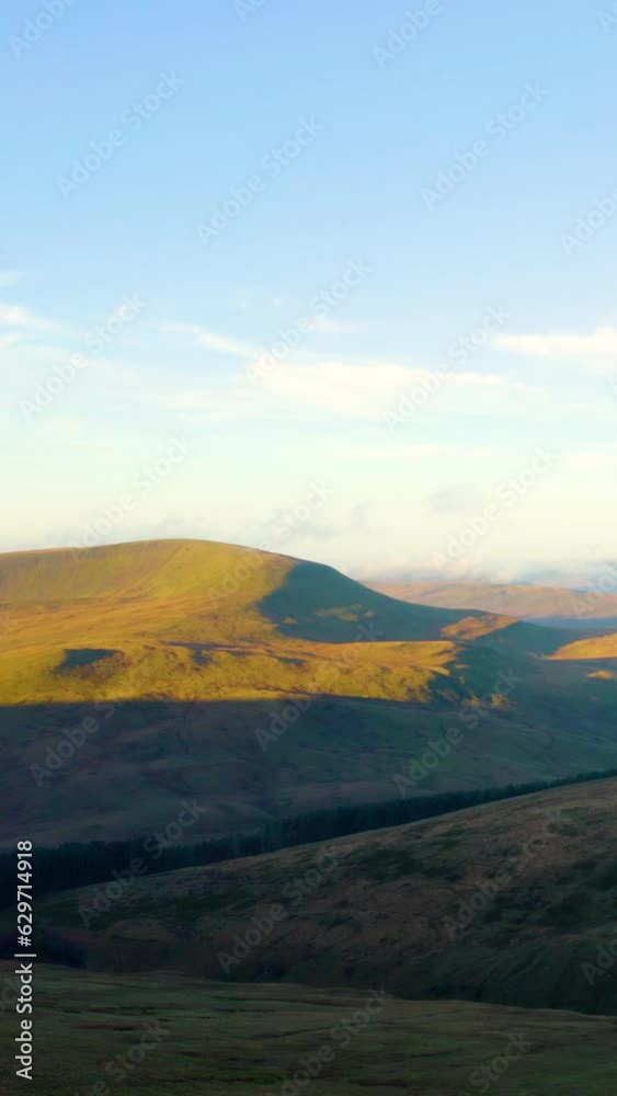 Time Lapse of Brecon Beacons National Park in Wales. Time lapse of vibrant landscape with hills and flying cloudscape at blue sky. Brecon Beacons National Park, Wales. Aerial vertical, vertical video. Time Lapse of Brecon Beacons National Park in Wales. Time lapse of vibrant landscape with hills and flying cloudscape at blue sky. Brecon Beacons National Park, Wales. Aerial vertical, vertical video.