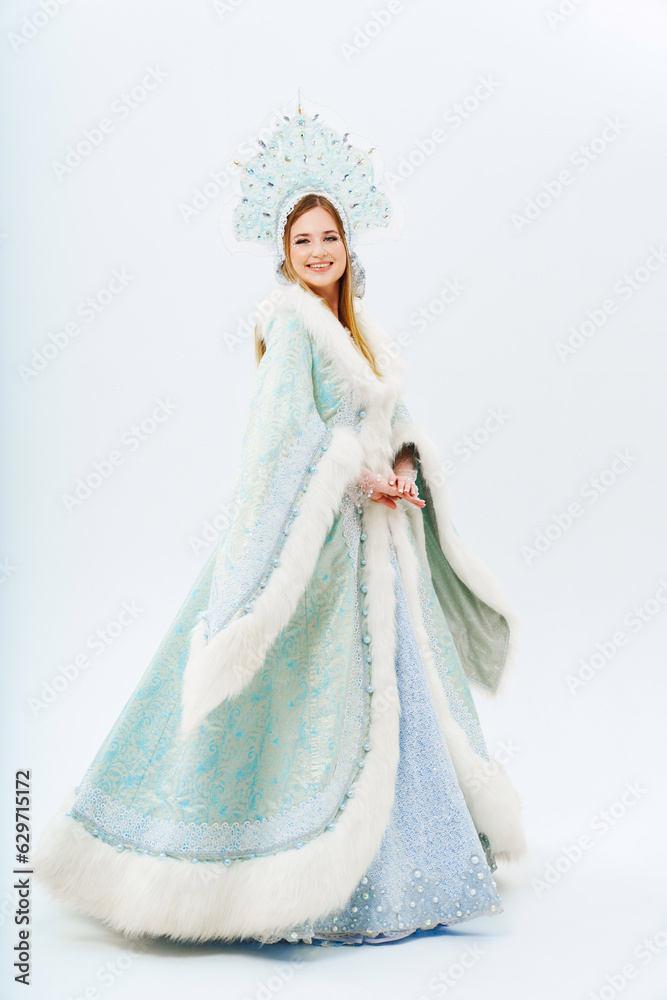 Snow Maiden in a traditional costume with a kokoshnik on a white background. Snow Maiden in a traditional costume with a kokoshnik on a white background.