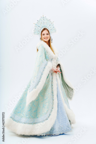 Snow Maiden in a traditional costume with a kokoshnik on a white background. 