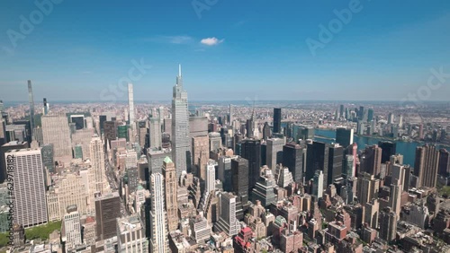 Beautiful aerial view of Manhattan's skyscrapers on blue sky background on bright summer day. USA.