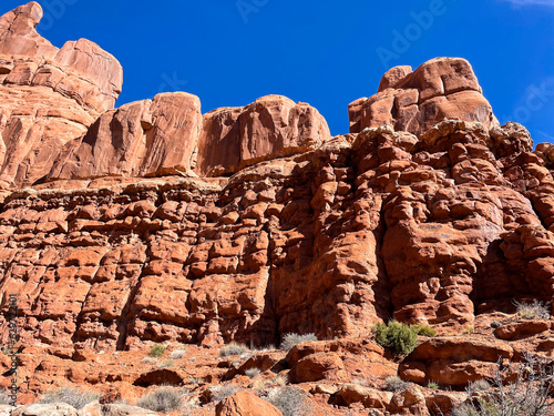 Moab, Utah, looking at the amazing rock formations created due to erosion from wind and water on the sandstone with Red Rock Cliffs carved by the Colorado River