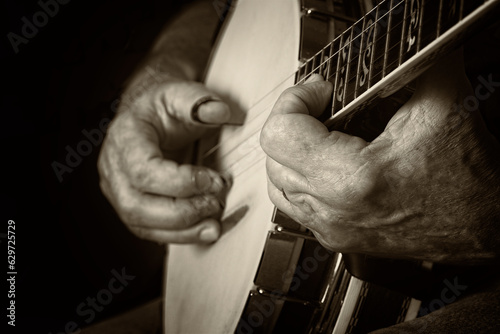 Banjo player playing bluegrass country music on a sepia background