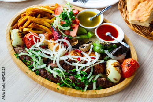 Kebab, barbecue vegetables, tkemali lavash sauce tomatoes, peppers. Georgian cuisine photo