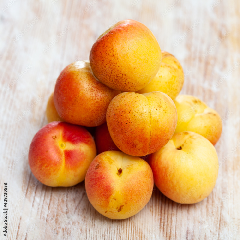 Image of ripe juicy apricots on wooden table, nobody