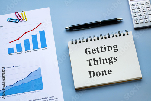 There is notebook with the word Getting Things Done. It is as an eye-catching image. photo
